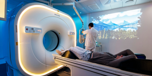 imagén de un tomografo en sala de tomografia con tecnico operando